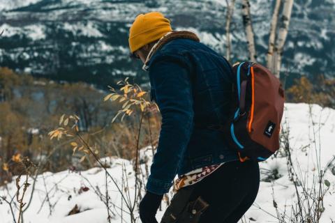 A hiker in winter gear on snow