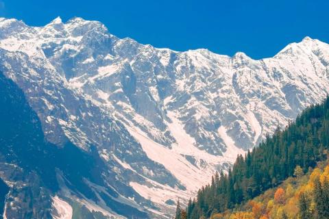 Snowy peaks above autumn foliage in Himachal Pradesh