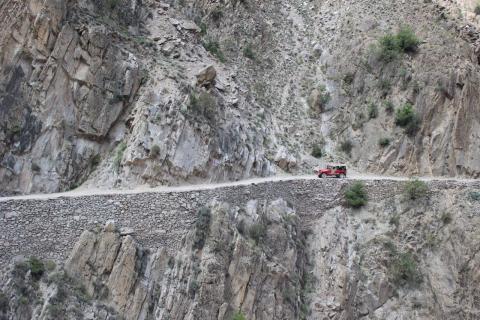 A road cut into a rock face in the Himalayas
